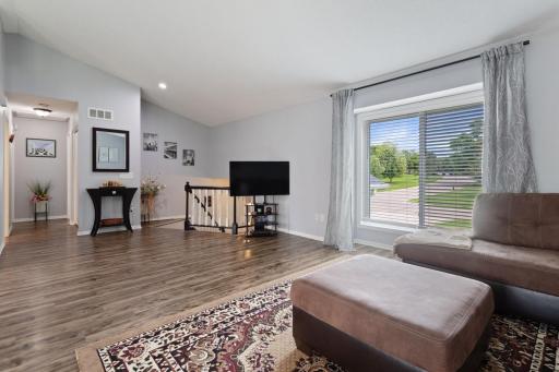 The hallway leads to the upper level bedrooms and includes a double-door pantry closet, perfect for additional storage. Great guests at the covered front porch into the inviting foyer with luxury vinyl plank flooring and convenient coat closet.