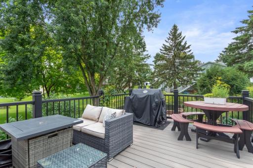 The 16 x 12 maintenance free deck with built-in LED stair lighting. The stairs lead down to the fenced backyard with a concrete fire pit area and gazebo covered hot tub, creating an ideal outdoor space for relaxing and entertaining.