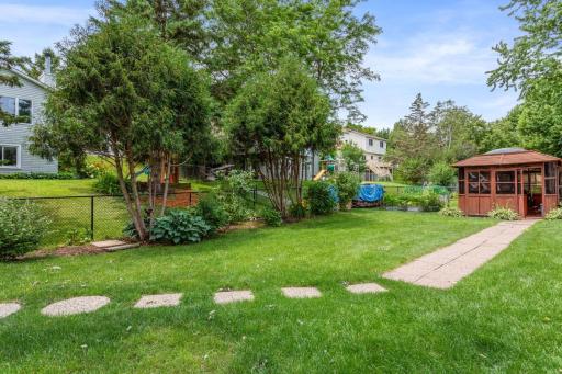 This backyard features a 10 x 10 gazebo with hot tub, creating the perfect space to relax and unwind. This private backyard retreat is ideal for entertaining or enjoying peaceful evenings year-round.