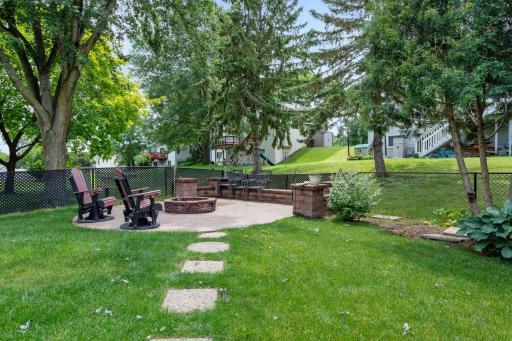 Enjoy evenings around the custom fire pit featuring a poured concrete patio, built-in retaining wall seating, and integrated drainage to help keep the fire pit dry after rain.