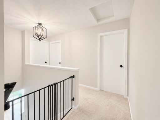 Hallway with updated carpet, paint and lighting fixture