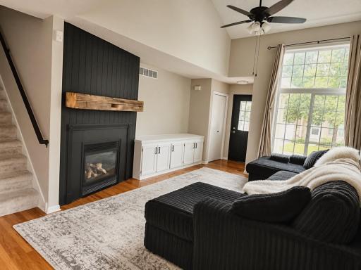 Dramatic shiplap fireplace with authentic barnwood beam, entertainment center and 2 story Vaulted celing!