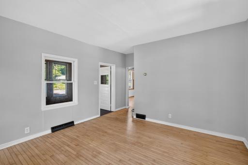 The living room also has clear maple flooring. Windows to the south and east bring in lots of light, and windows to the front porch bring in afternoon light.