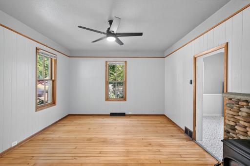 The front room off the kitchen could be used as a dining room. It has refinished clear maple floors and windows to the north and west.