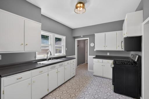 The updated kitchen has lots of counter space and a double window to the back yard.