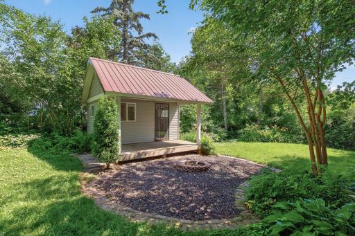The back yard is your private oasis of shade and relaxation. The sweet storage shed has a metal roof and a covered porch.
