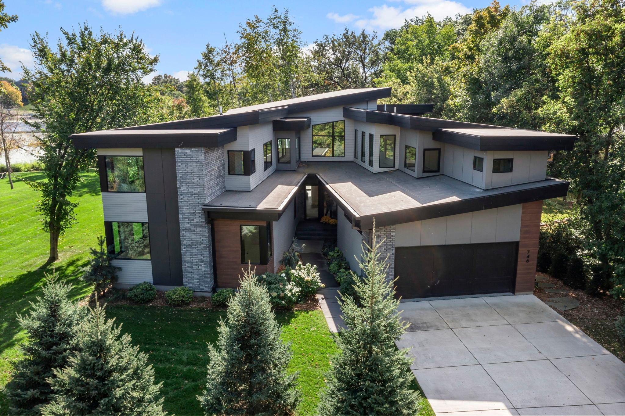An extraordinary, 5-bed / 5 bath, modern home offering a stunning shoreline with picturesque views and tons wooded privacy on a spectacular 1.28 acres