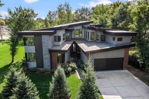 An extraordinary, 5-bed / 5 bath, modern home offering a stunning shoreline with picturesque views and tons wooded privacy on a spectacular 1.28 acres
