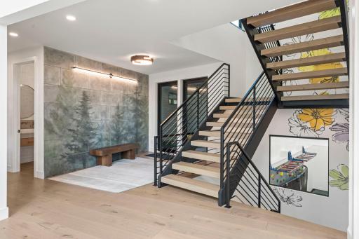 The custom built open staircase is a must see