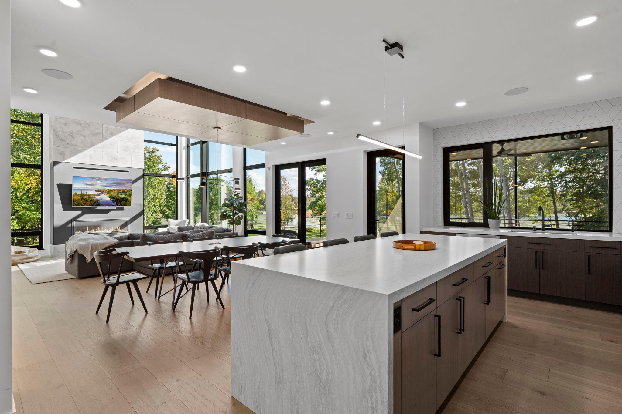 Showcasing a waterfall-edge granite island, this oversized centerpiece balances sleek design with everday funtionality.