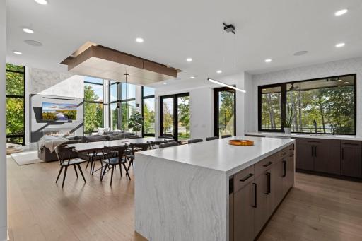 Showcasing a waterfall-edge granite island, this oversized centerpiece balances sleek design with everday funtionality.