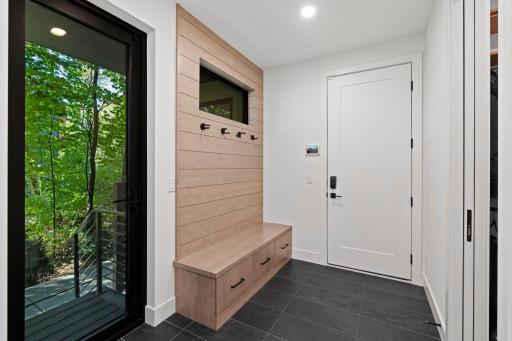 Stylish mudroom featuring designer tile and a charming shiplap benchâwhere function meets flair.