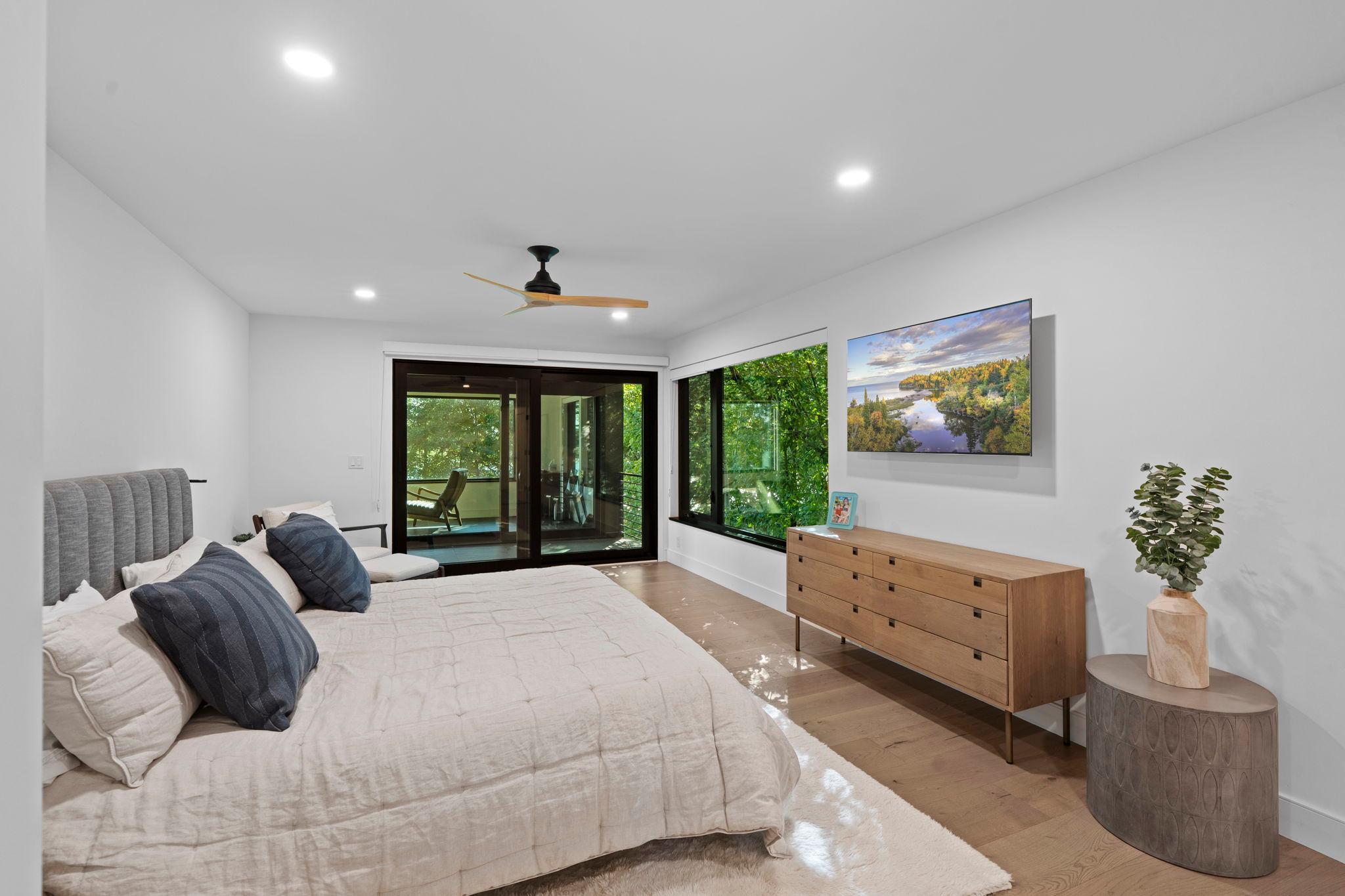Luxurious Primary bedroom with private walkout to detached screened porch.