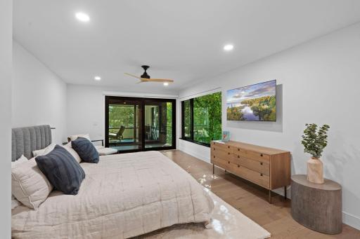 Luxurious Primary bedroom with private walkout to detached screened porch.