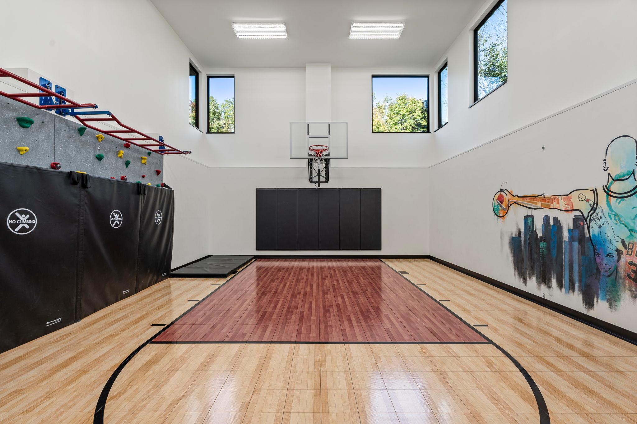 Massive, interior sport court is ready to provide a lifetime of fun right in the comforts of home - basketball, climbing wall and attached exercise room.