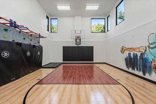 Massive, interior sport court is ready to provide a lifetime of fun right in the comforts of home - basketball, climbing wall and attached exercise room.