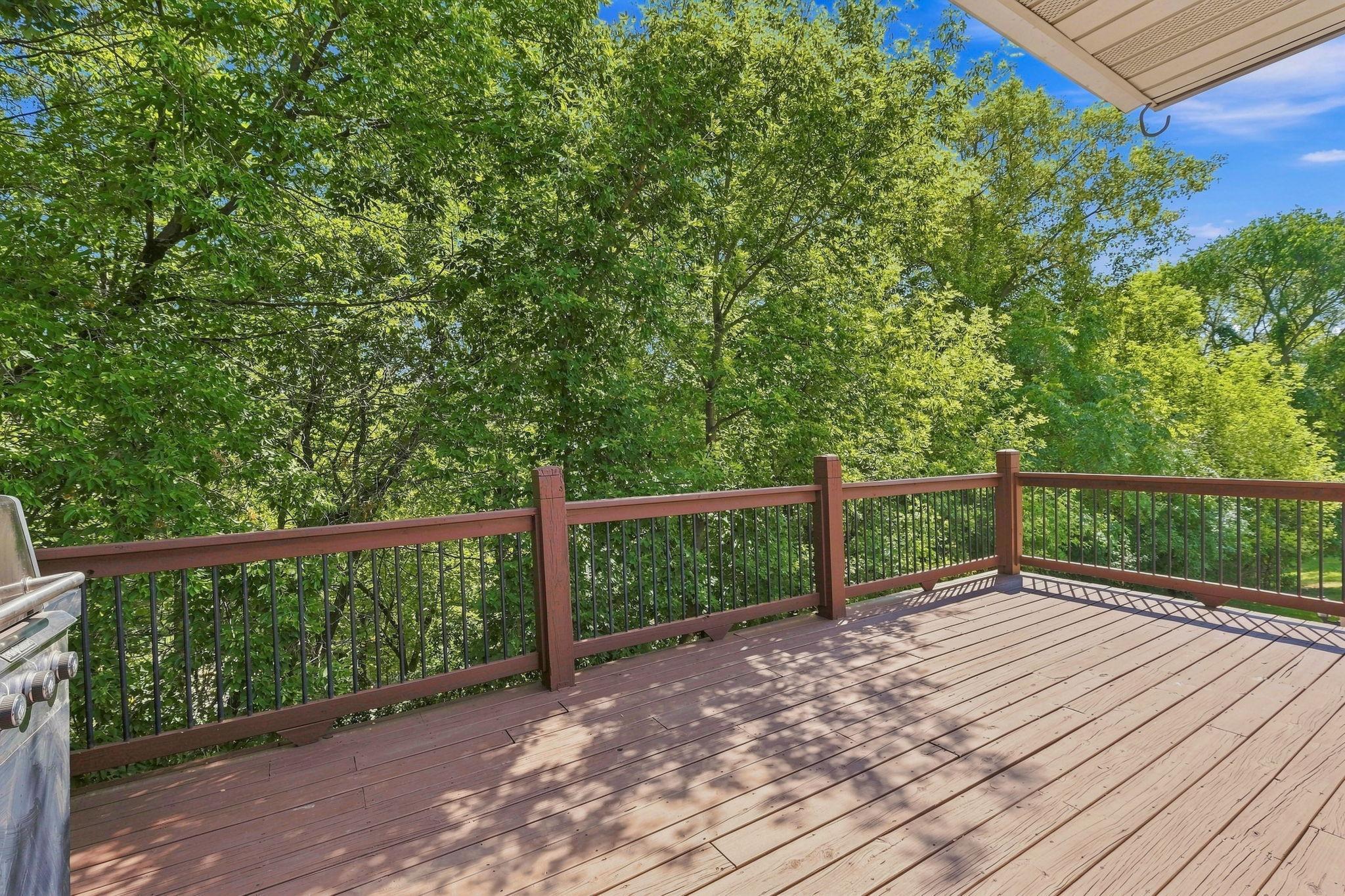 Large deck overlooking the backyard with easy access to the kitchen, making outdoor entertaining a breeze.