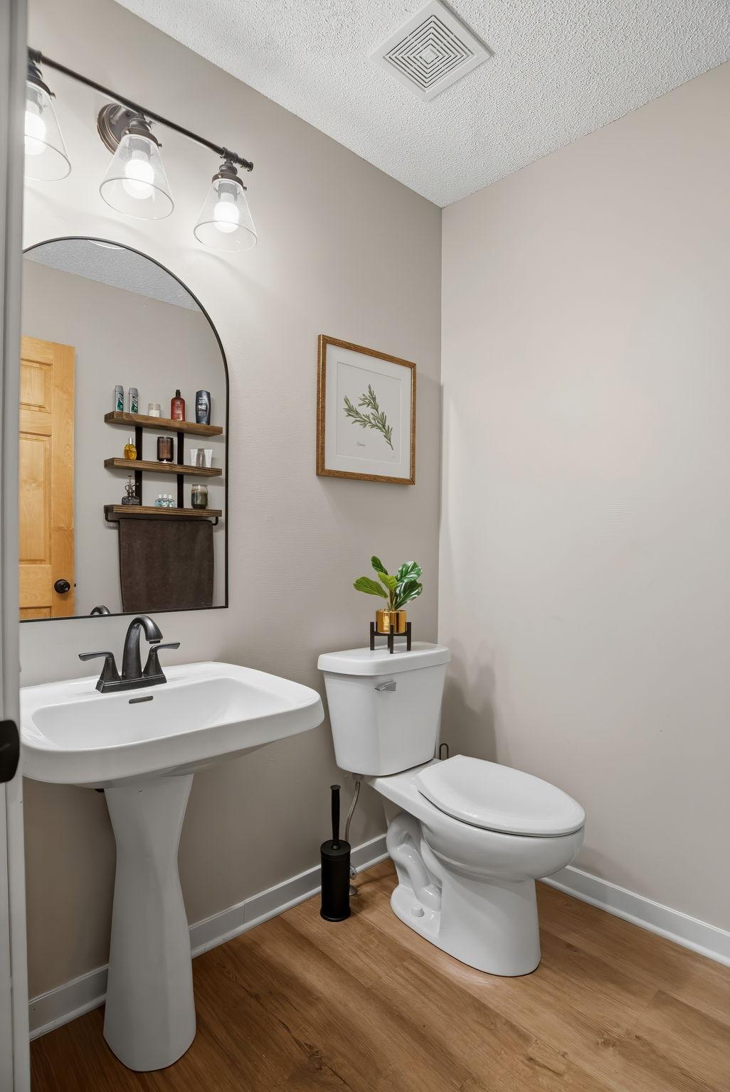 Main floor powder room adjacent to the laundry/garage entry