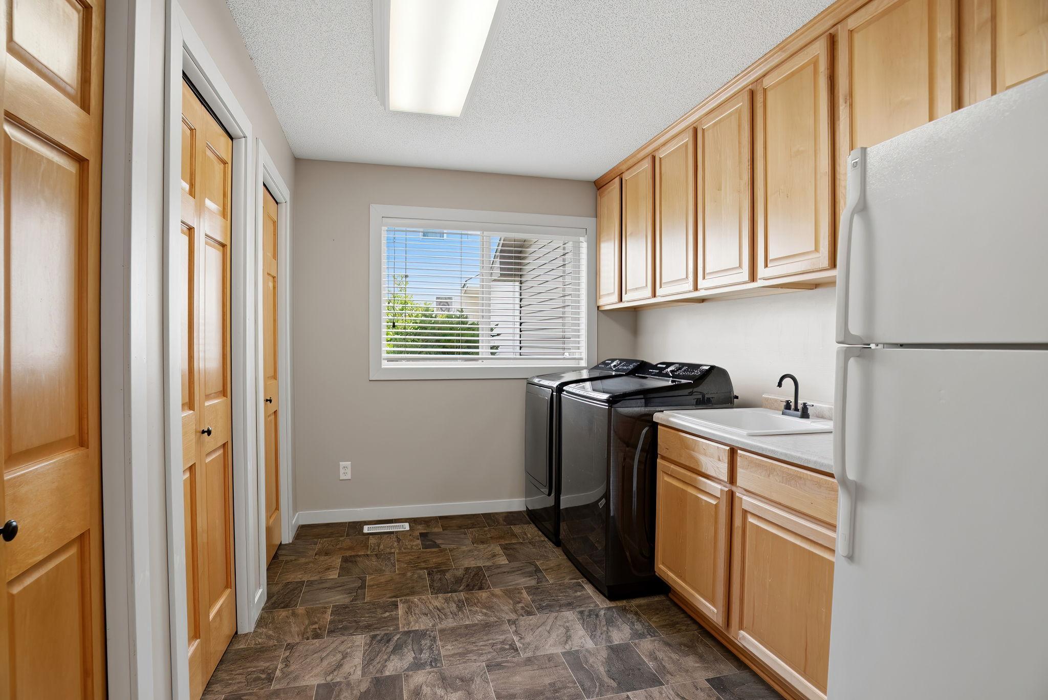 The main floor laundry overs a 2nd storage refrigerator, newer samsung w/d and an expansive storage closet!
