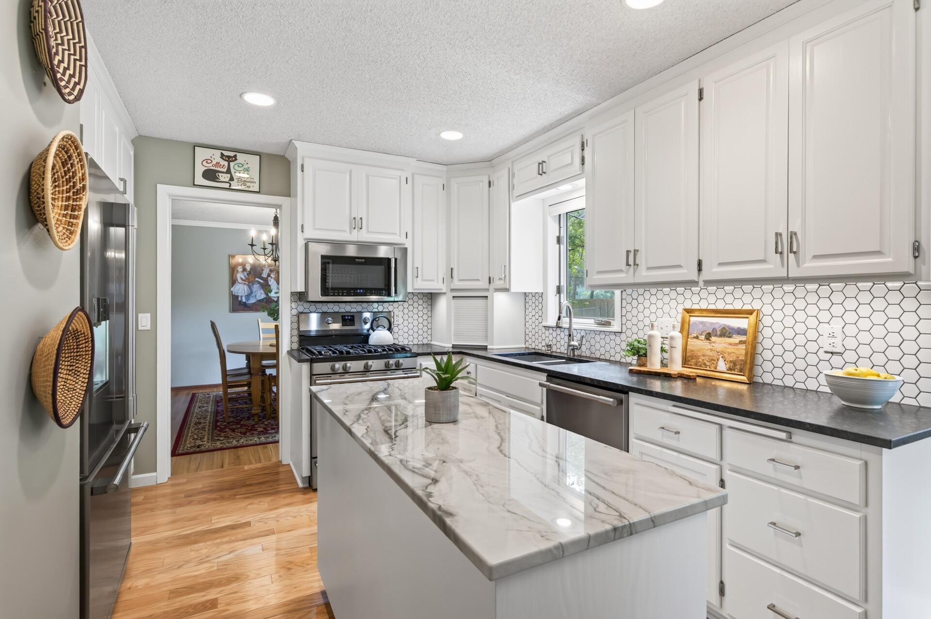 Updated kitchen with granite countertops and stainless steel appliances