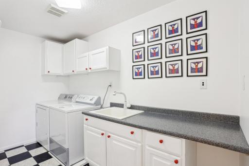 Convenient laundry room is situated on the upper level adjacent to the kids rooms.
