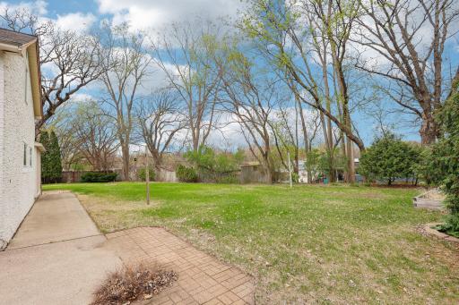 The backyard is private, flat and has potential for a pool, or great space to throw a ball or handout by the fire pit.