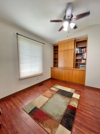 Den off the living room features built-in shelfing and storage. This space could easily be converted to a legal third bedroom!