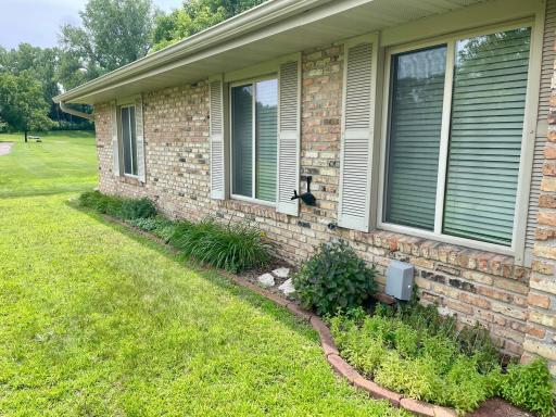 Perennial gardens add low maintenance beauty to this home.
