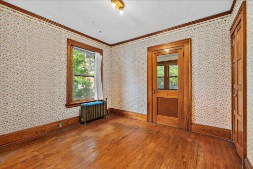 The "normal sized" rear bedroom with attached sleeping porch/office.