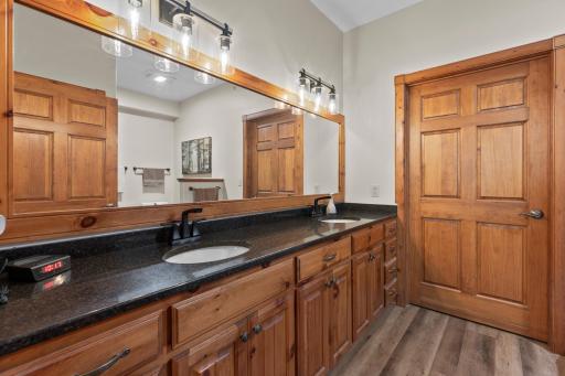 Double sinks & lots of cabinets - door to walk-in closet