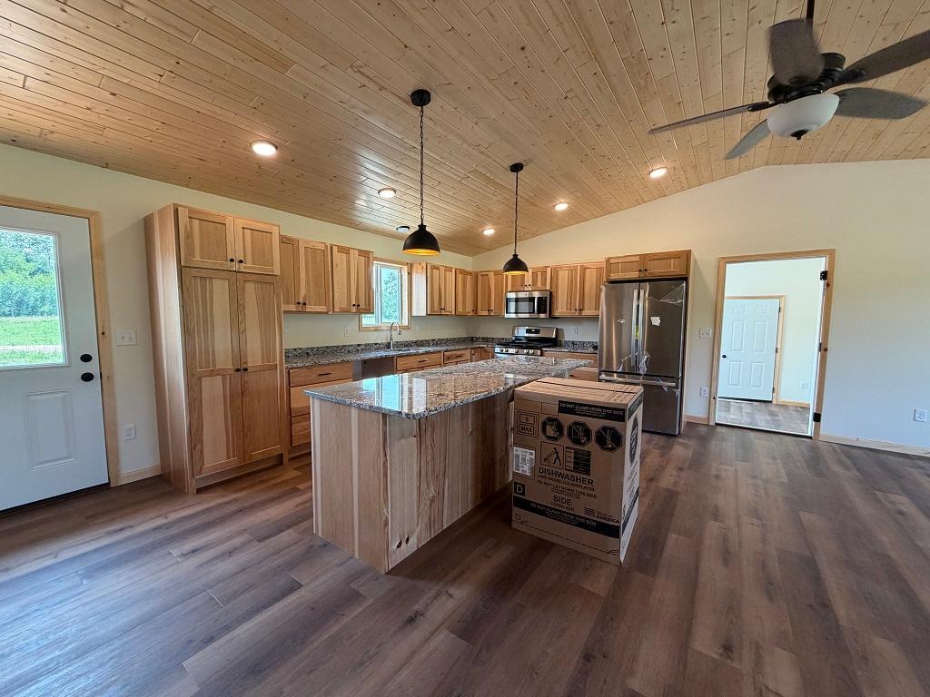 Spacious kitchen with hickory cabinets and granite counter.