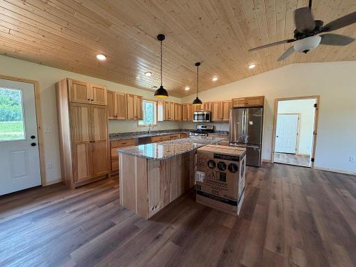 Spacious kitchen with hickory cabinets and granite counter.