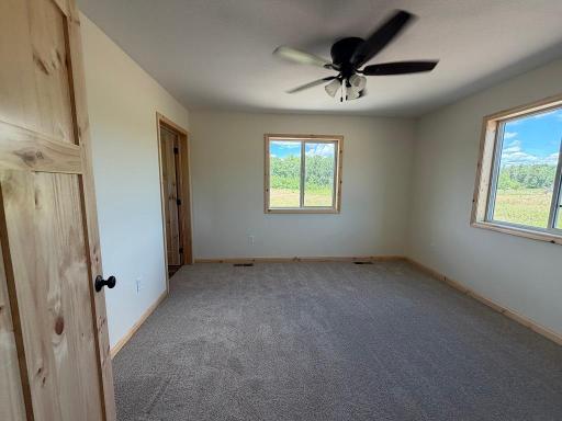 Primary bedroom with 3/4 bath and walk-in closet.