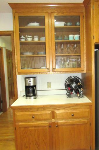 The beverage center with glass front cabinets.