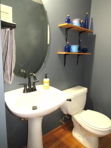 Attractive and freshly painted main floor 1/2 bath with hardwood floors.