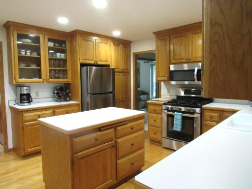 A cooks dream! The kitchen has everything! Tons of cabinets and counter space, lazy susan, center island with pull-out drawers, stainless steel appliances, hardwood floors, recessed lighting and easy access to the dining room.
