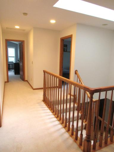 The upper level staircase separates the primary and 2nd bedroom from bedroom 3 and 4. There are recessed lights, a sky-light and linen center.