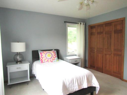 One of the 4 upper level bedrooms with a double closet, ceiling lighting and fresh paint.
