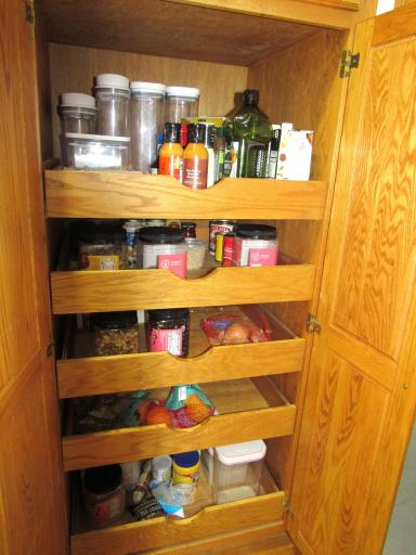 The pantry cupboard has convenient pull-out drawers.