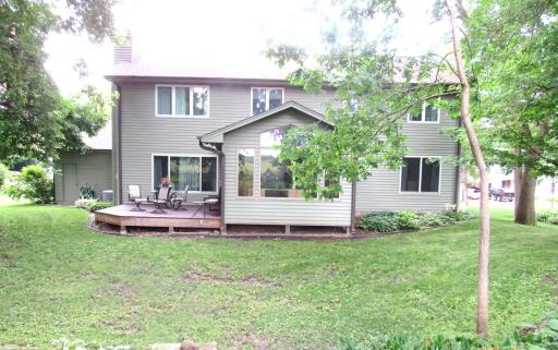 As you look from the deck to the rear yard, the yard goes back beyond the treed area into another open area.