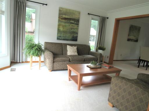 The big front room has a bay window that brings in natural light. There is a race track ceiling to compliment the dining room ceiling.