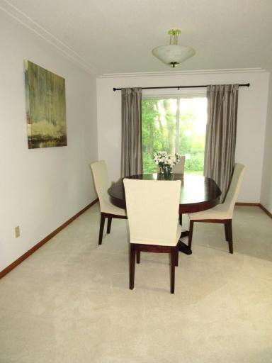 The spacious dining room is open to the living room. It has a race track ceiling for added ambiance.