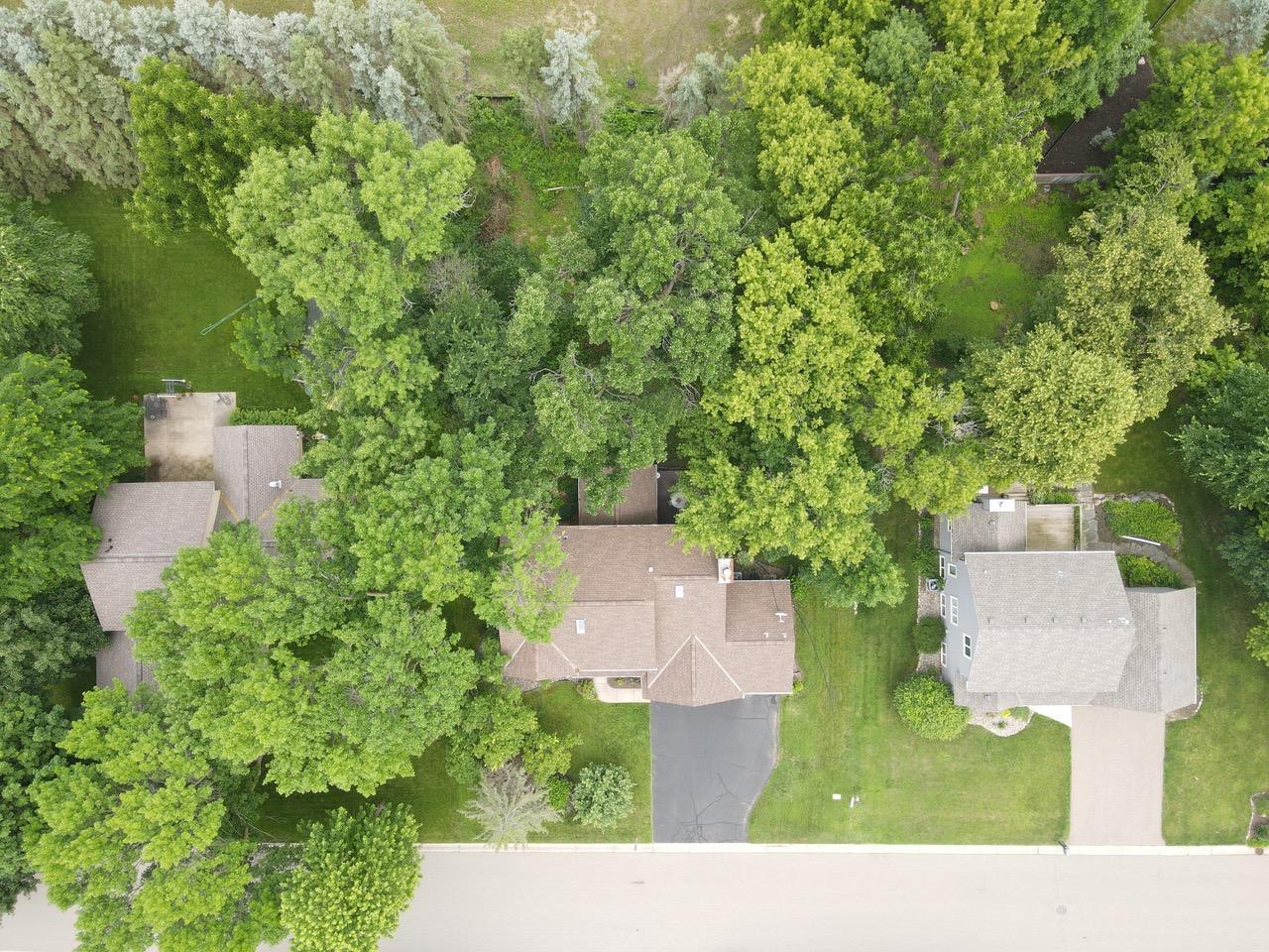 Woodsy rear yard but there are 2 open spaces. Walk the little path between the trees and there is another open space. Upper bracket homes are going up just north of the property.