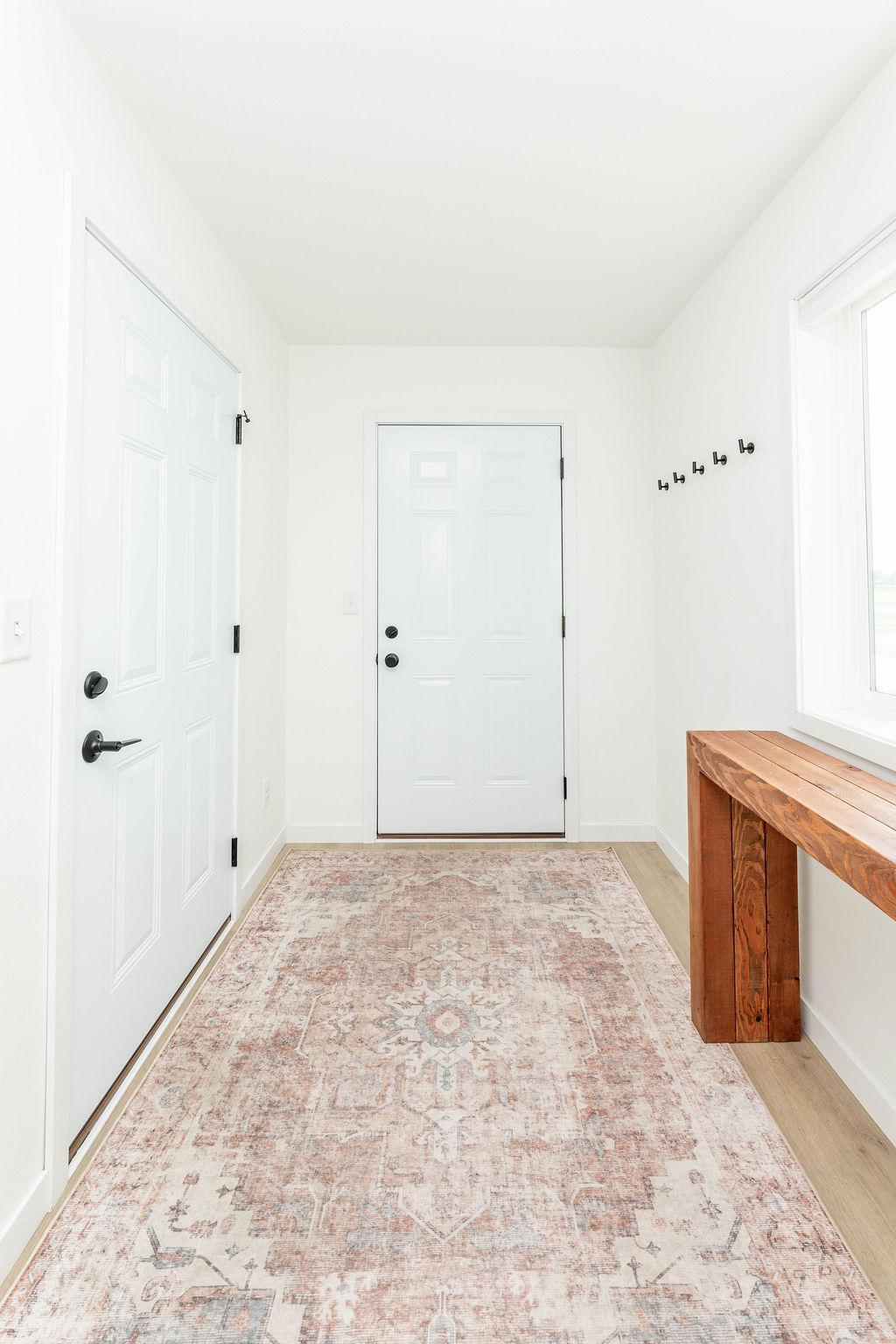 Welcoming Foyer with Hooks and Space for Bench