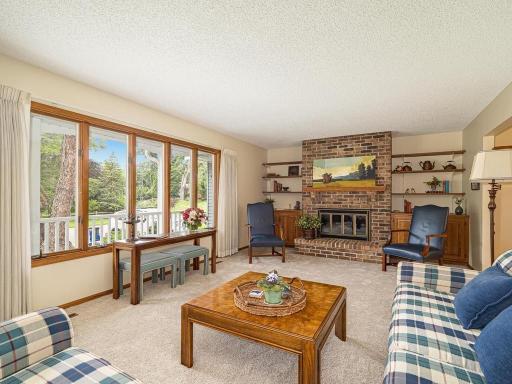 Living room features New Carpet installed July 2026 ! Wall of windows lets the natural light illuminate the room.