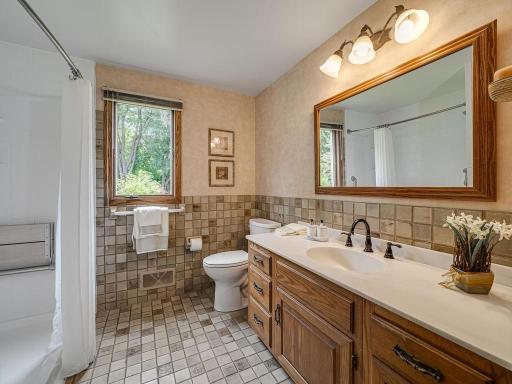 Main floor 3/4 bath with newer handicap accessible low step-in shower easy to use if in wheel chair or walker. Ceramic tile bathroom floor .