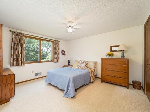 1st of the two upper level bedrooms with spacious closets. Large window offers beautiful view of backyard.
