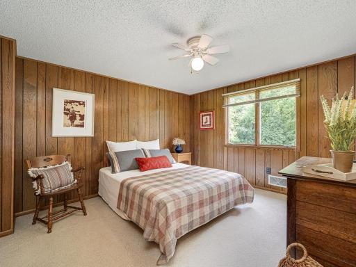 Classic wood paneling in the 2nd upper level bedroom makes you feel like you are up north relaxing at the cabin. Large window overlooks backyard.