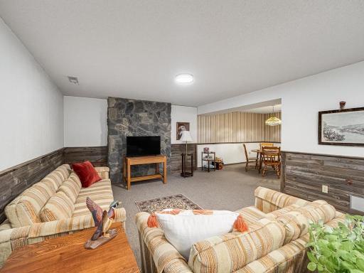 Lower level family room with game room in upper right corner. Naturally aged barnwood accent on lower half of wall.