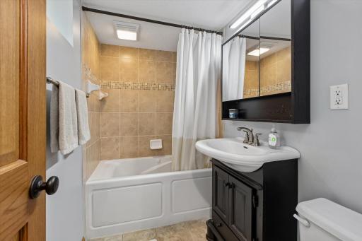 Updated tile surround and modern finishes make this bathroom move-in ready from day one